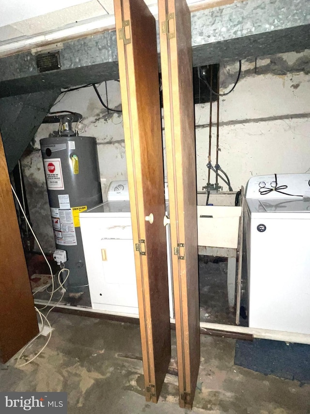 utility room featuring water heater and washer / dryer