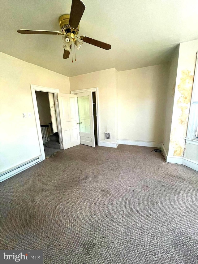 unfurnished bedroom featuring ceiling fan, baseboard heating, and carpet floors