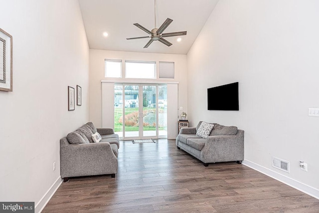 living room featuring ceiling fan, plenty of natural light, high vaulted ceiling, and hardwood / wood-style flooring