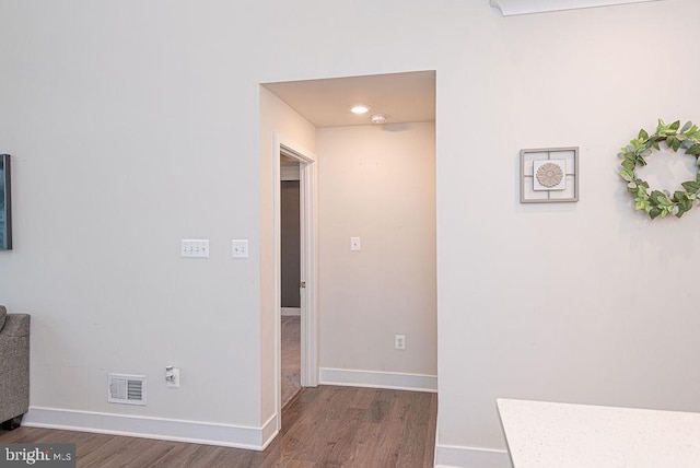 hallway with hardwood / wood-style flooring