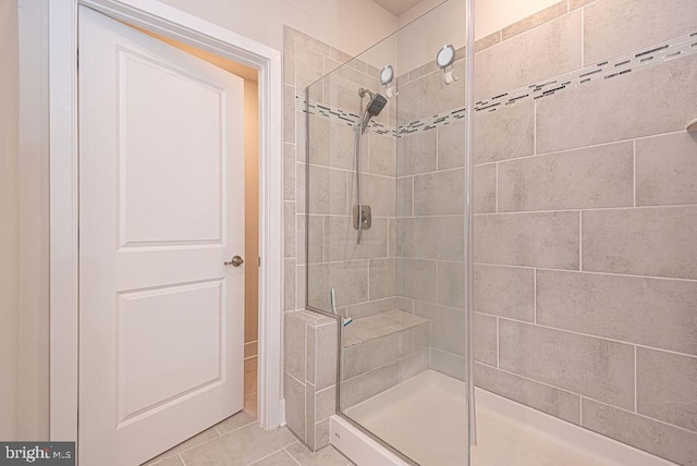 bathroom featuring tile patterned flooring and a shower with shower door