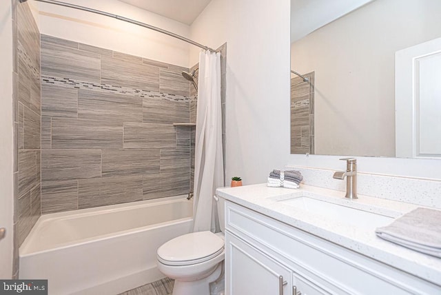 full bathroom featuring shower / bath combo, vanity, and toilet