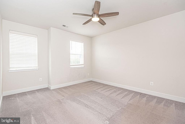 spare room featuring carpet flooring and ceiling fan