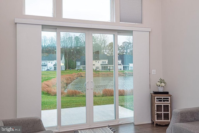 entryway featuring dark hardwood / wood-style flooring and a water view