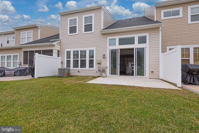 back of house with a yard, a patio area, and central air condition unit