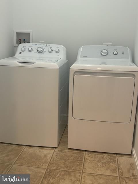 clothes washing area with washer and clothes dryer