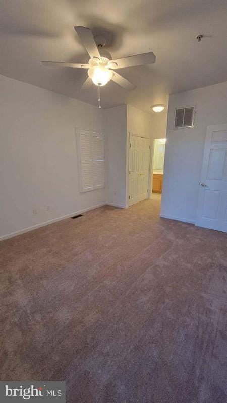 unfurnished room featuring ceiling fan and carpet flooring