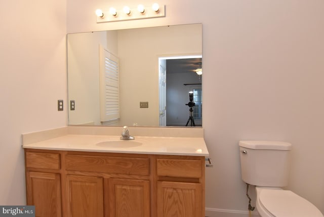 bathroom featuring ceiling fan, vanity, and toilet