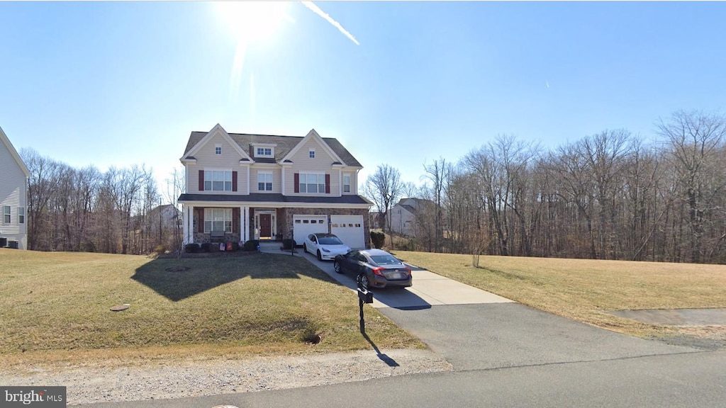 view of front of property with a garage and a front lawn