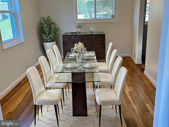 dining area with hardwood / wood-style floors