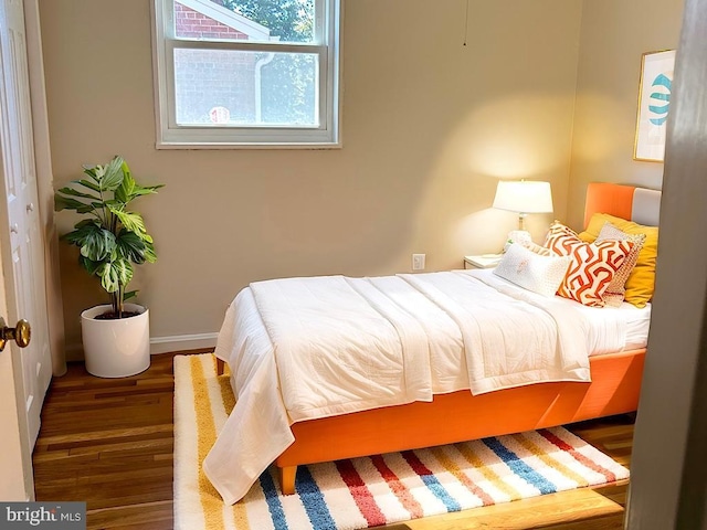 bedroom featuring hardwood / wood-style floors and a closet