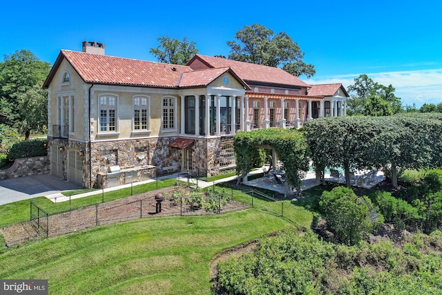 rear view of house with a lawn and a garage