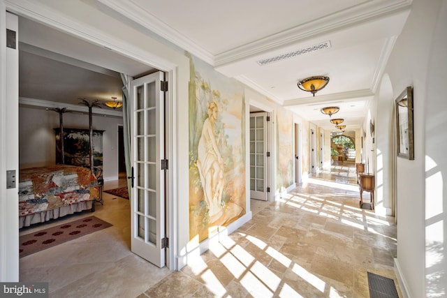 hall with ornamental molding, french doors, and a wealth of natural light