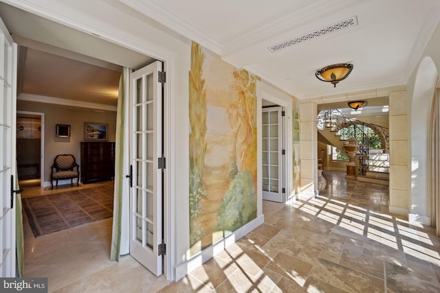 interior space with crown molding and french doors