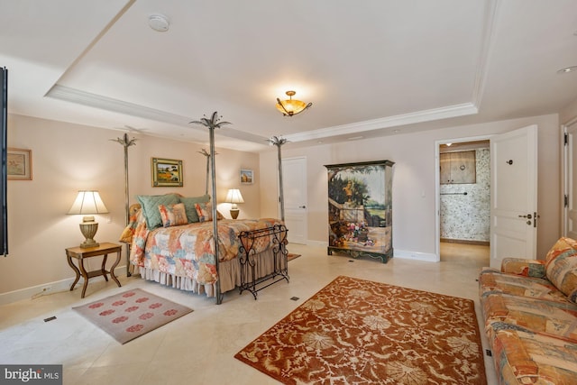 bedroom featuring a tray ceiling and connected bathroom