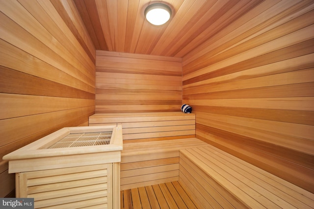 view of sauna / steam room featuring wood walls and wooden ceiling