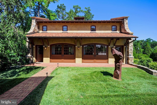 rear view of house with a lawn