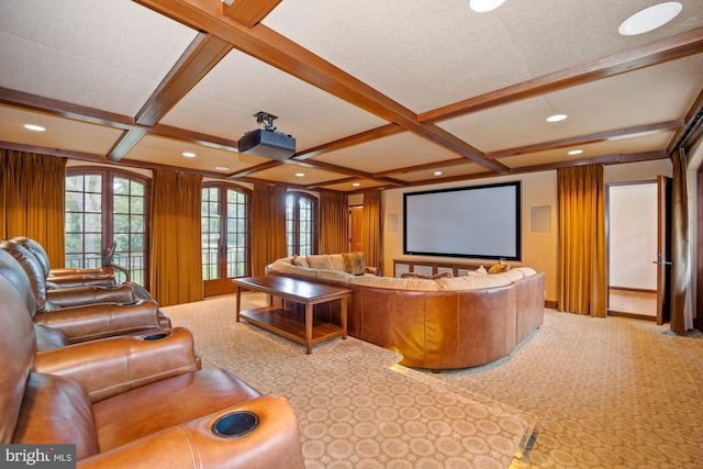 carpeted cinema with coffered ceiling, french doors, and beam ceiling