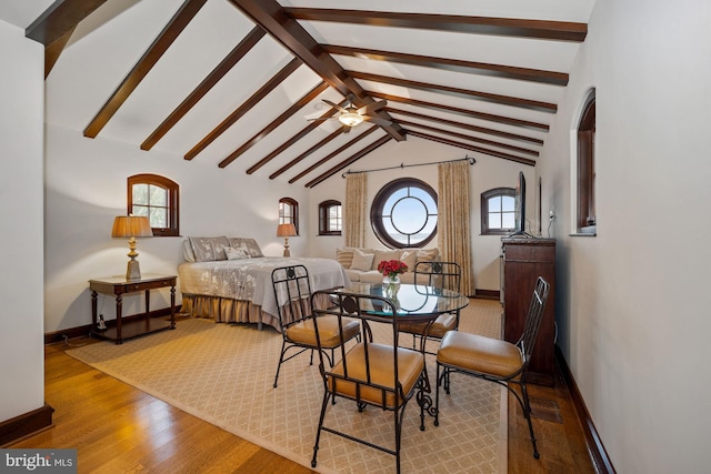 bedroom with multiple windows, hardwood / wood-style flooring, and vaulted ceiling with beams