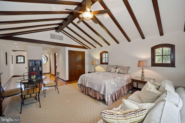 bedroom featuring ceiling fan, light wood-type flooring, and lofted ceiling with beams