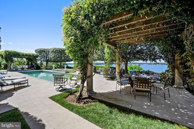 view of patio / terrace with a water view and a pergola