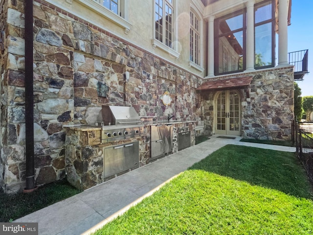 view of patio / terrace featuring french doors and an outdoor kitchen