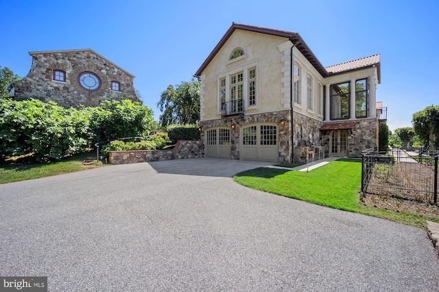 view of front of house with a front lawn, a garage, and cooling unit