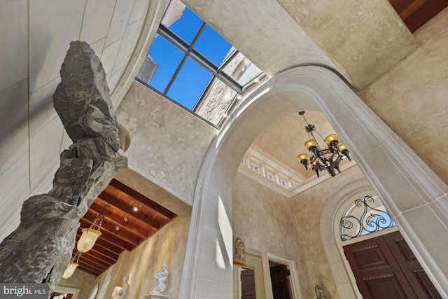 room details featuring beam ceiling and an inviting chandelier