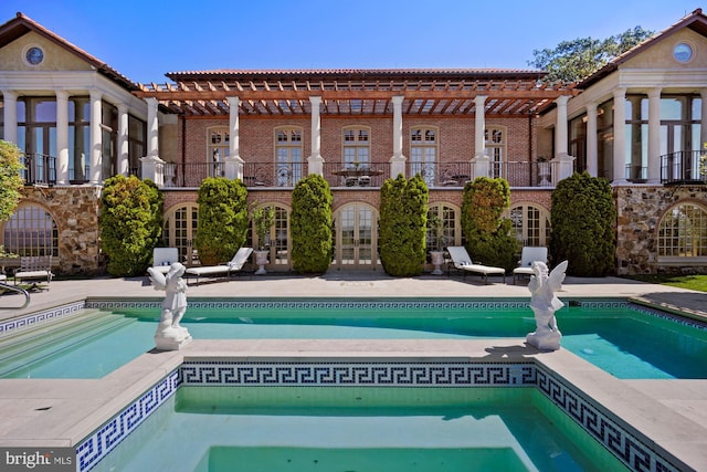 view of swimming pool with french doors and a patio area