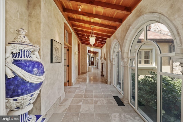 corridor featuring wood ceiling and vaulted ceiling with beams