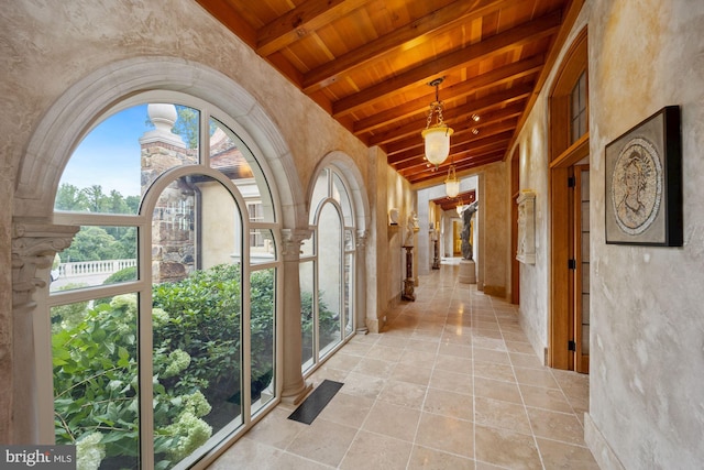 hallway with wooden ceiling and vaulted ceiling with beams