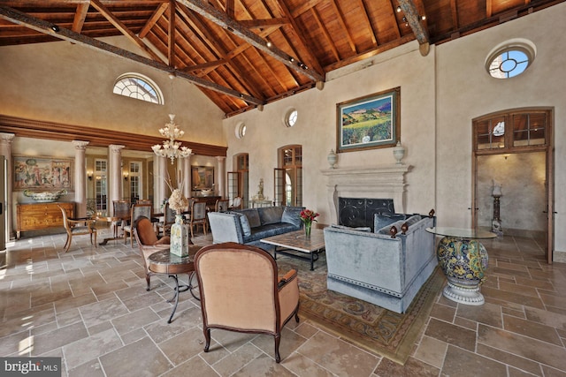 living room featuring high vaulted ceiling, wood ceiling, a chandelier, and beam ceiling