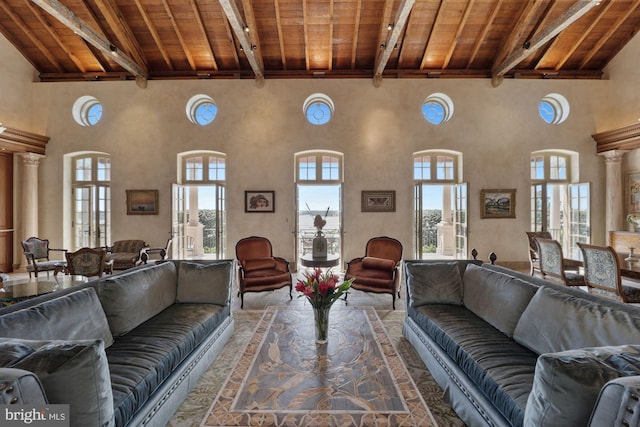 living room with ornate columns, high vaulted ceiling, beam ceiling, and wood ceiling