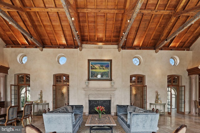 living room with high vaulted ceiling, wood ceiling, french doors, and beam ceiling