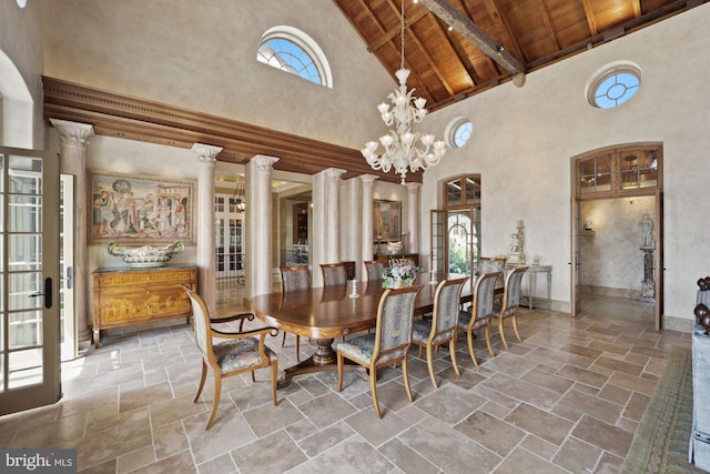 dining space with wood ceiling, ornate columns, high vaulted ceiling, and a notable chandelier