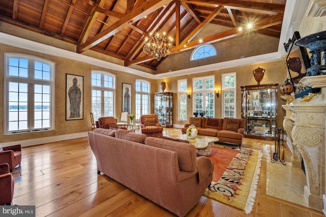 living room featuring beamed ceiling, a wealth of natural light, and light hardwood / wood-style flooring