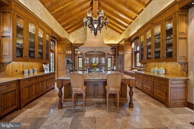 bar featuring light stone counters, an inviting chandelier, wooden ceiling, high vaulted ceiling, and beam ceiling