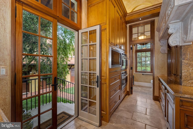 doorway with wood walls and plenty of natural light