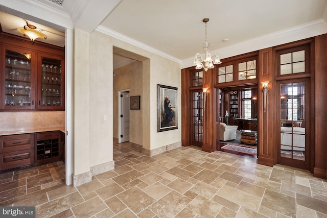 interior space with crown molding and a notable chandelier