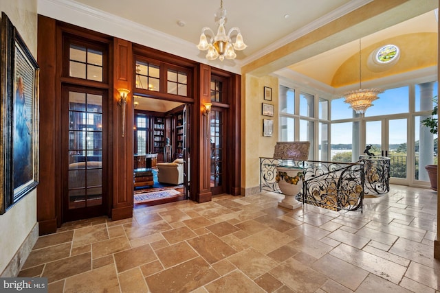 entrance foyer featuring a notable chandelier and crown molding