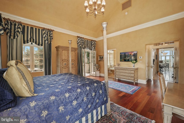 bedroom with dark hardwood / wood-style flooring, a high ceiling, an inviting chandelier, and ornamental molding