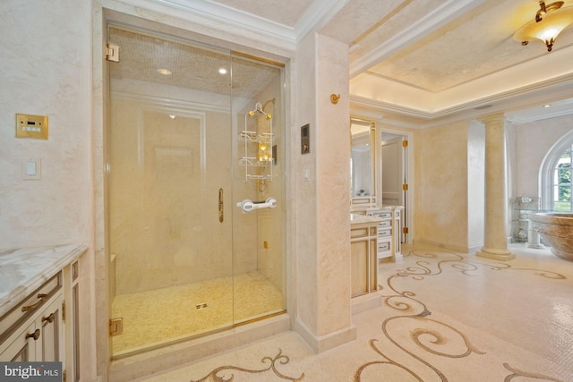 bathroom featuring a shower with shower door, vanity, ornate columns, and ornamental molding