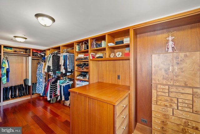 walk in closet with dark hardwood / wood-style flooring