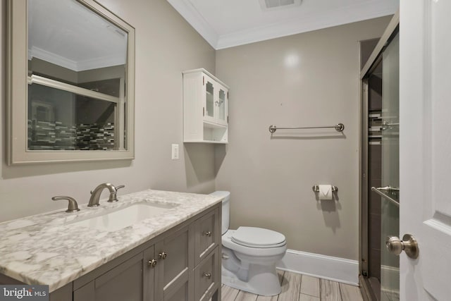 bathroom featuring toilet, vanity, hardwood / wood-style floors, and crown molding