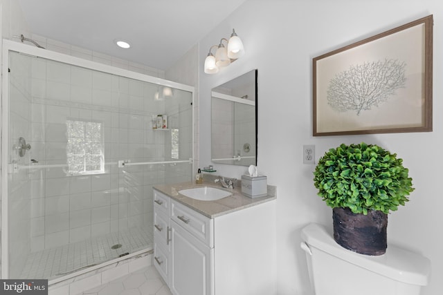 bathroom with tile patterned flooring, vanity, toilet, and walk in shower