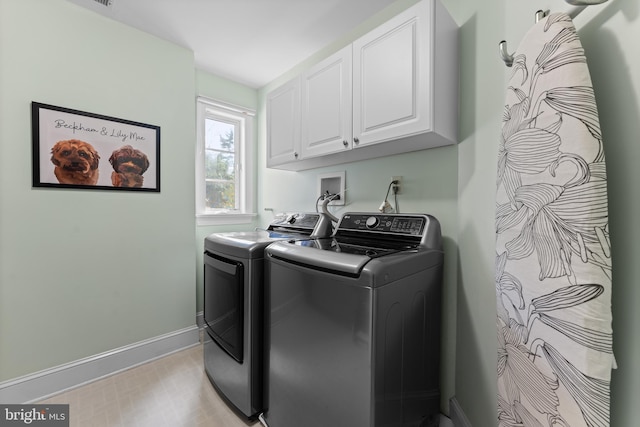 laundry room with cabinets, separate washer and dryer, and light hardwood / wood-style flooring