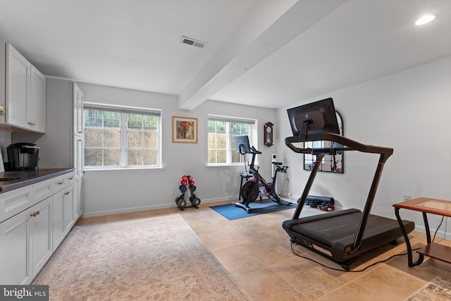 workout room featuring light tile patterned floors