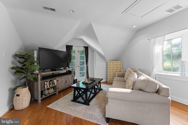 living room with vaulted ceiling and hardwood / wood-style flooring