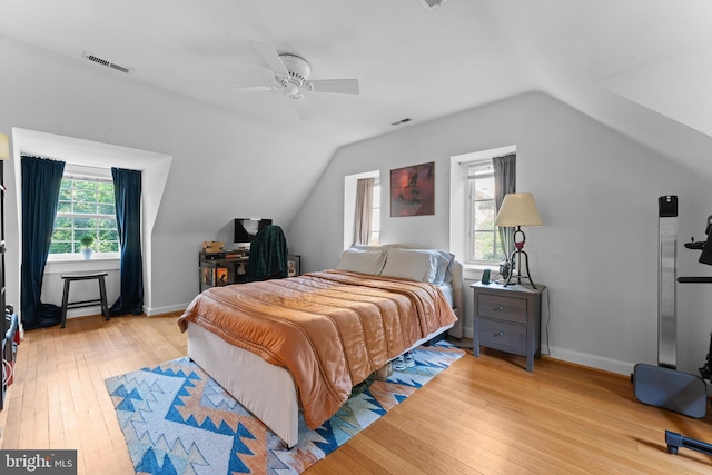 bedroom with light hardwood / wood-style floors, multiple windows, and ceiling fan