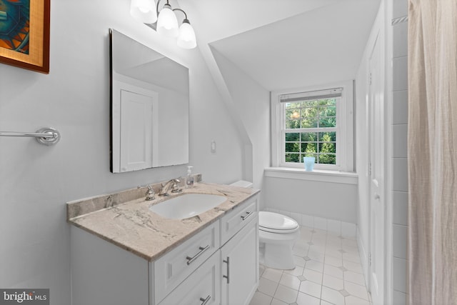 bathroom with tile patterned flooring, vanity, and toilet